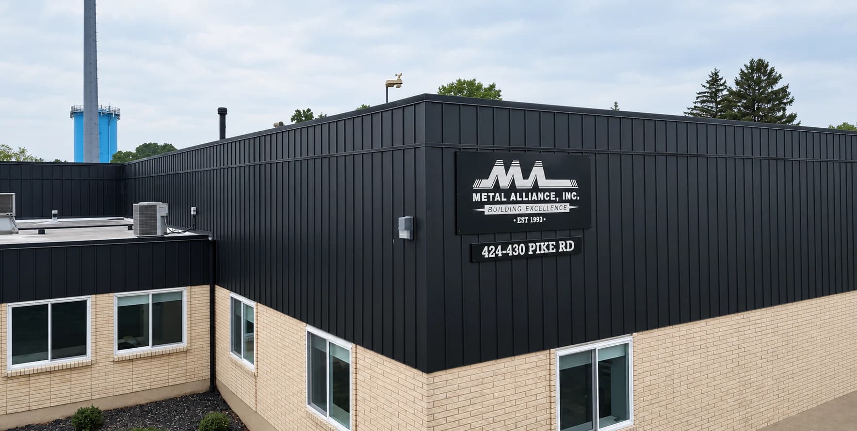 The Metal Alliance, Inc. building on Pike Road: dark metal wall panels over tan brick, with the Metal Alliance sign and the 424–430 Pike Rd address.